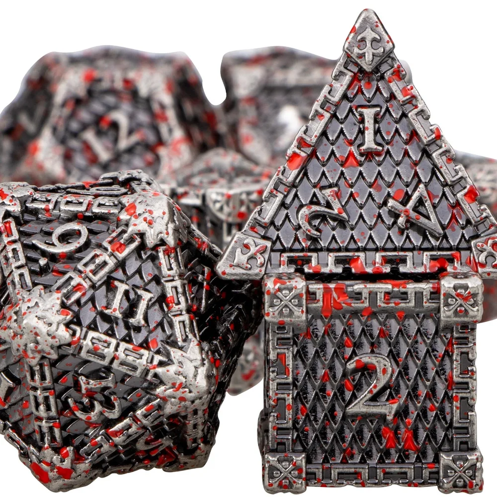 Close-up of silver-coloured dragon-scale dice with red accents and recessed numerals