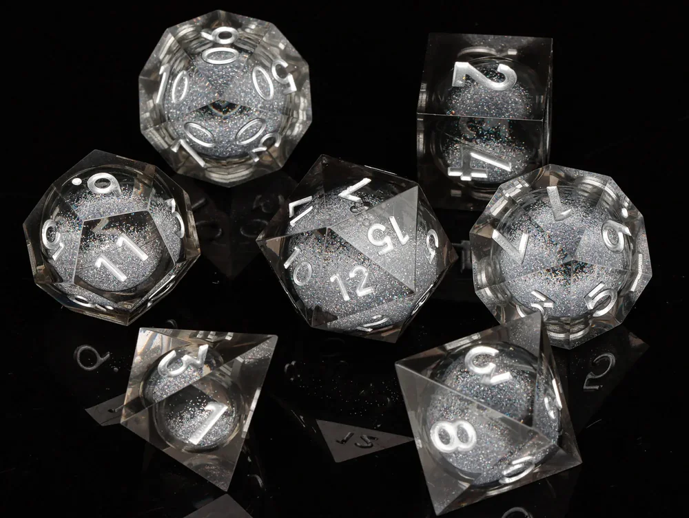 Clear polyhedral dice with glitter-filled spherical centres and silver-coloured numerals