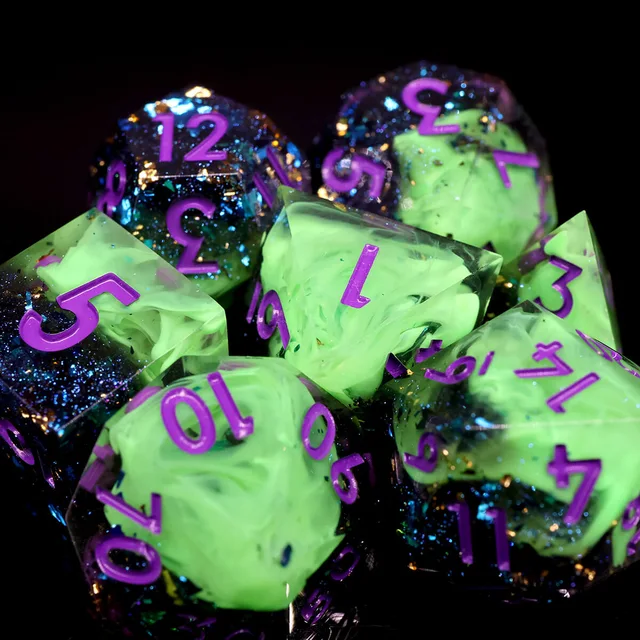 Close view of green-swirled dice with purple numbers and glittering dark sections.