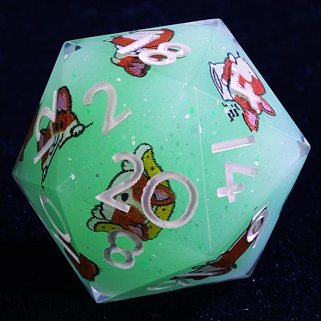 Close-up of a mint-green D20 with corgi illustrations and pale numerals.