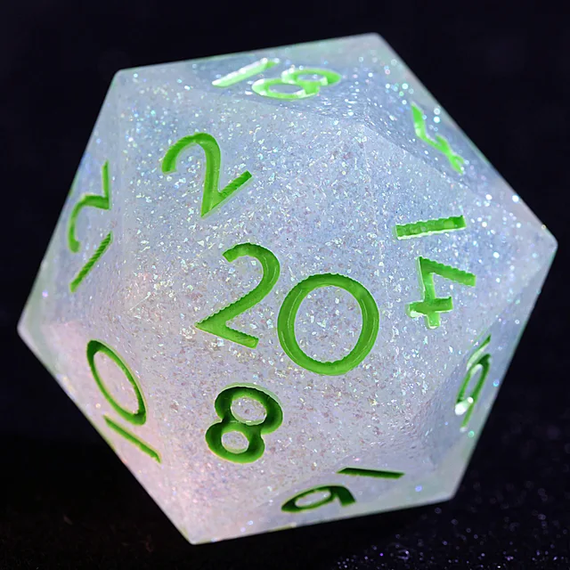 Close-up of a pale translucent glitter D20 with green numerals.