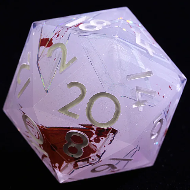 Close-up of a pale translucent D20 with red patches, angular lines and light-coloured numbers.