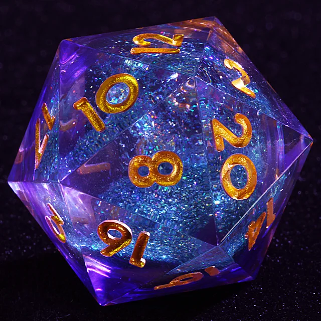 Close-up of a clear D20 with a glittery blue core and gold numbers.