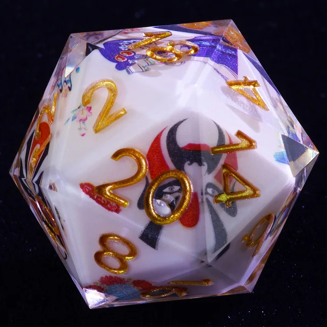Close-up of a clear-edged D20 with a white interior, gold numbers, and a red-and-black opera-style face.