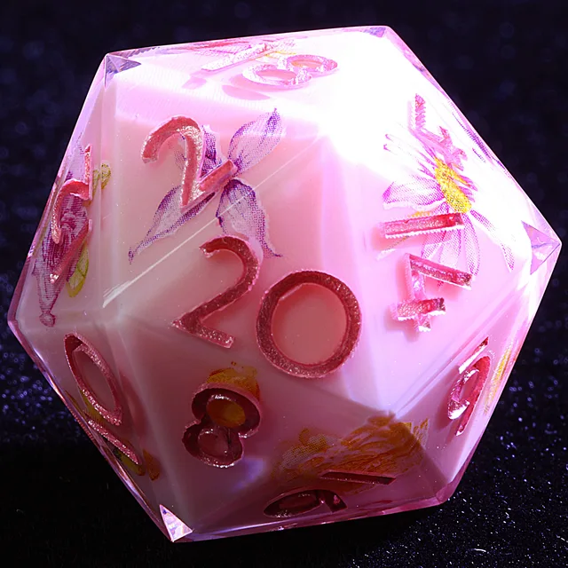 Close-up of a pale pink floral D20 with pink numerals.