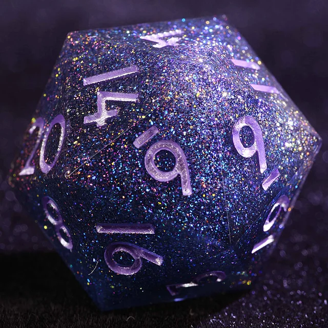 Close-up of an angular dark blue-purple die with multicoloured glitter and pale lavender numbers.