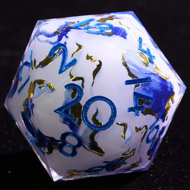 Close-up of a white translucent D20 with blue and gold swirls and glittery blue numbers.