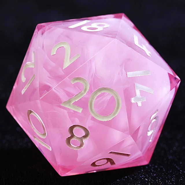 Close-up of a pink D20 with white swirls and pale numerals.