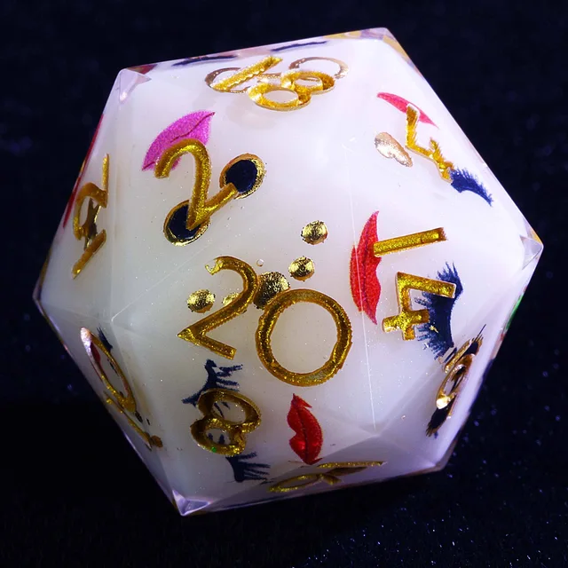 Close-up of a white D20 with gold numbers, pink and red lips, and dark eyelash designs.