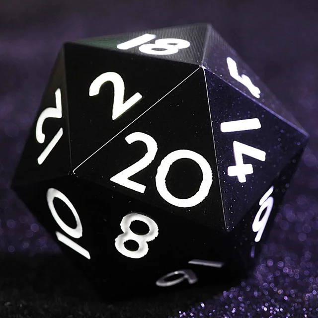 Close-up of a black D20 with white numerals.