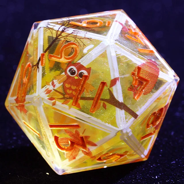 Honey-yellow resin D20 with owl and autumn leaf illustrations, white borders and orange numbers.