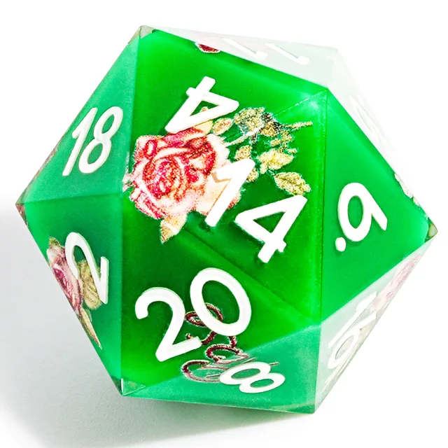 Close-up of a green D20 with white numerals and a pink rose detail.
