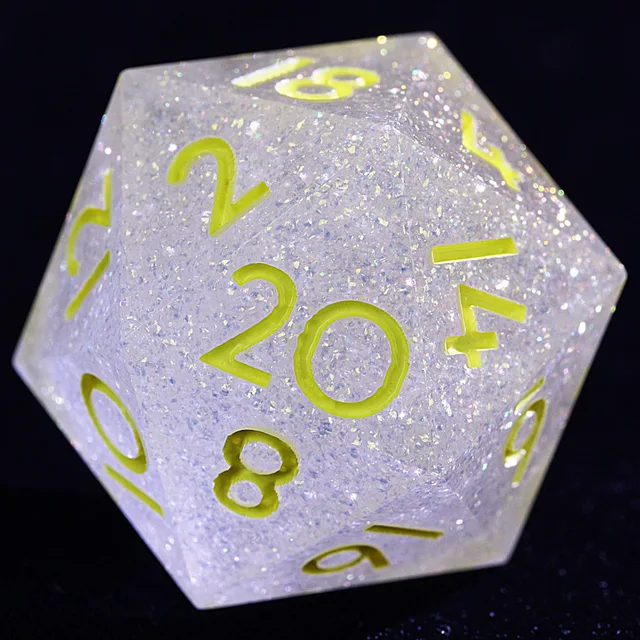 Close-up of a pale translucent glitter-filled D20 with yellow-green numerals.