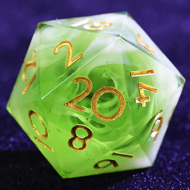 Close-up of a green and white swirled D20 with gold numbers.