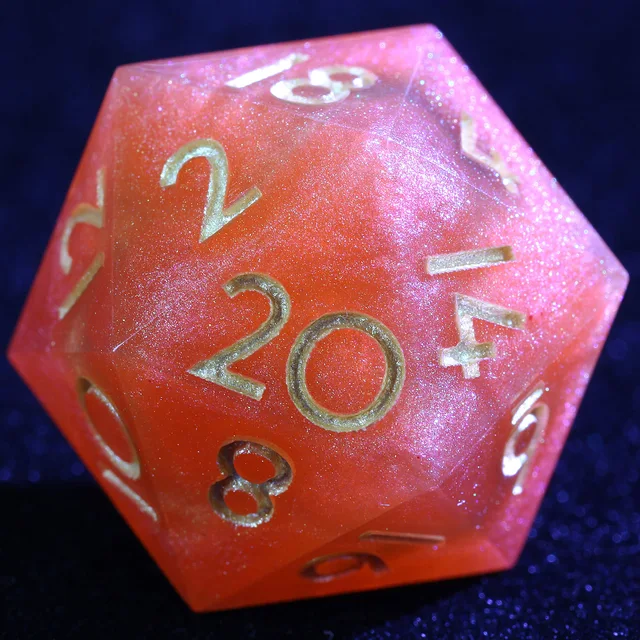 Close-up of an orange-red shimmering D20 with gold-coloured numerals.
