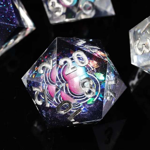 Close-up of a celestial D20 with a pink-and-blue sphere and silver numbers.