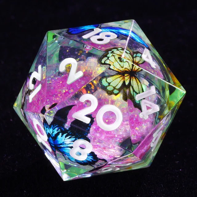 Close-up of a clear D20 with white numbers, pink glitter and blue and yellow butterflies.