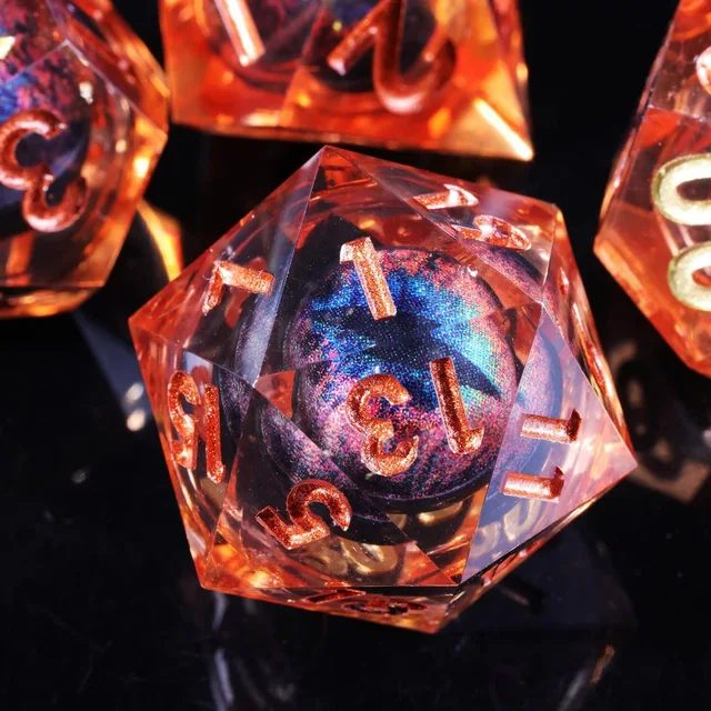 Close-up of an orange D20 with a blue-purple iridescent core.