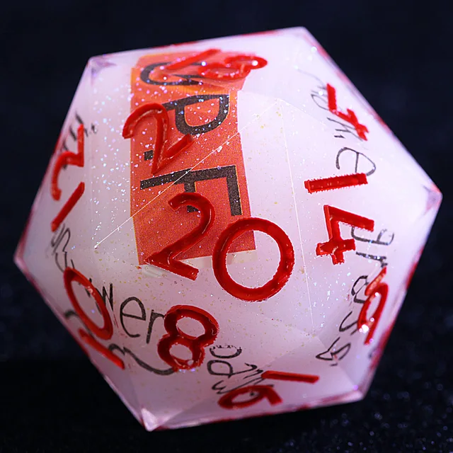 Close-up of the pale translucent D20 with red numbers, black lettering, and fine sparkle.