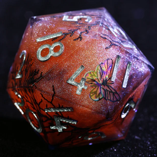 Close-up of an orange-red and purple D20 with silver numbers, a butterfly design, and dark branching lines.