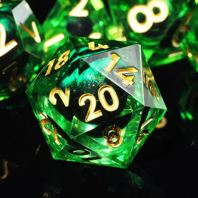 Close-up of a transparent green D20 with gold numbers and an emerald eye-like core.