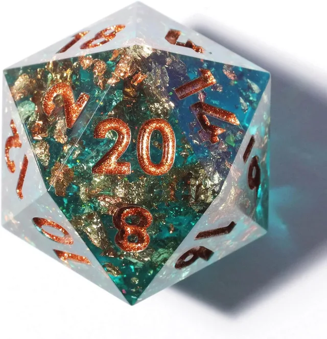 Close-up of a teal and clear D20 with gold flakes and copper-gold numbers.