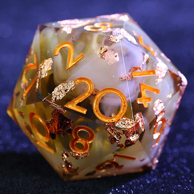Close-up of a swirled amber D20 with gold-coloured foil and numerals.