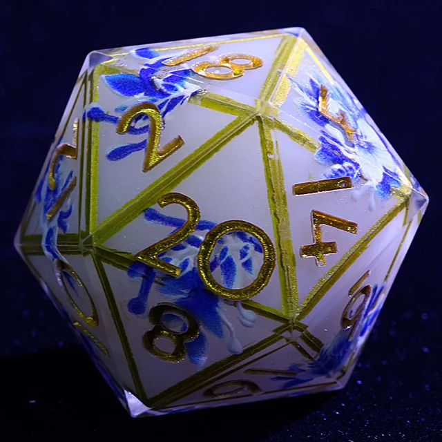 Close-up of the white and blue floral D20 with gold-coloured numbers and borders.