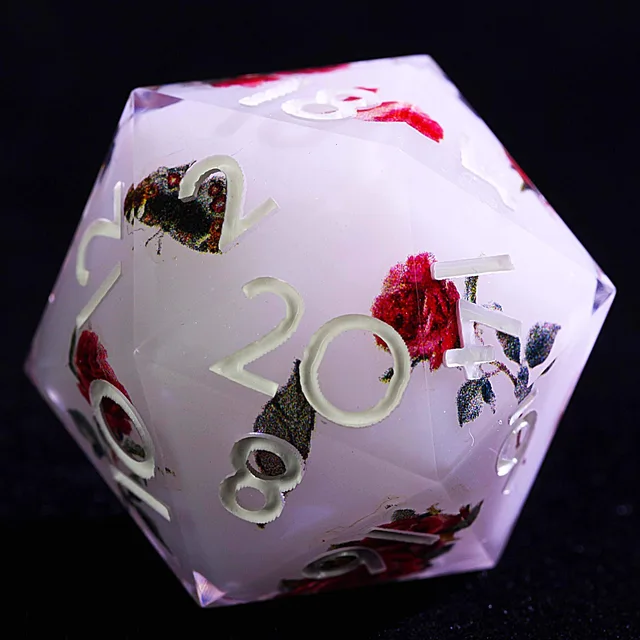 Close-up of a pale lavender-white D20 with white numbers, red roses, and butterfly details.