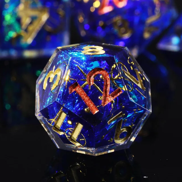 Close-up of a blue D12 with a red twelve and gold details.