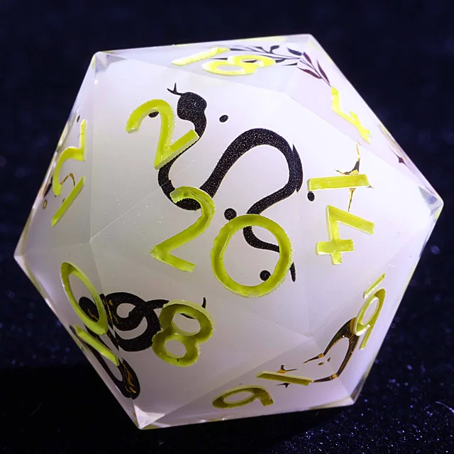 Close-up of a pale D20 with yellow-gold numbers and black serpent designs.