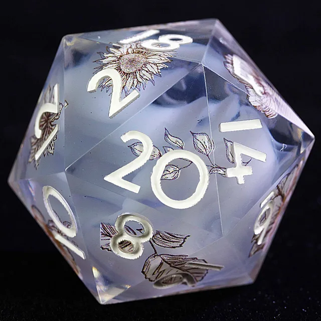 Close-up of a translucent smoky lavender-gray D20 with white numbers and floral and leaf illustrations.