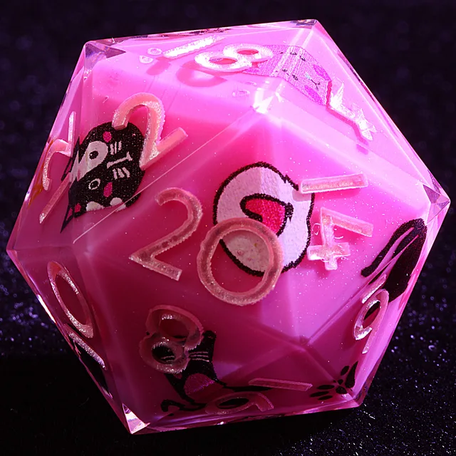 Close-up of a pink D20 with cat illustrations and pale numbers.