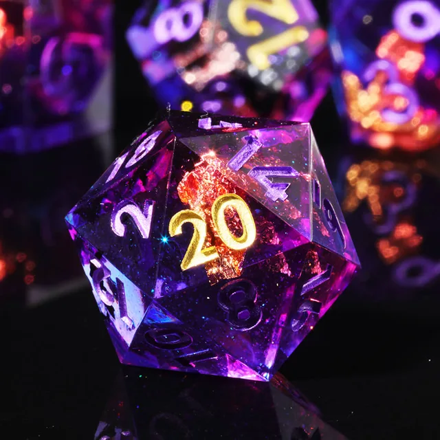 Close-up of a purple D20 with a gold 20 and copper-coloured flecks.