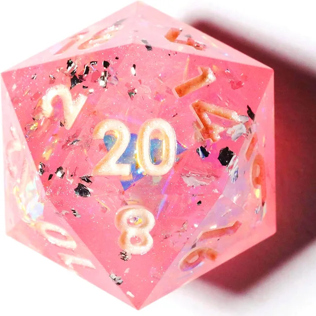 Close-up of a pink D20 with white numerals, dark flecks and iridescent inclusions.