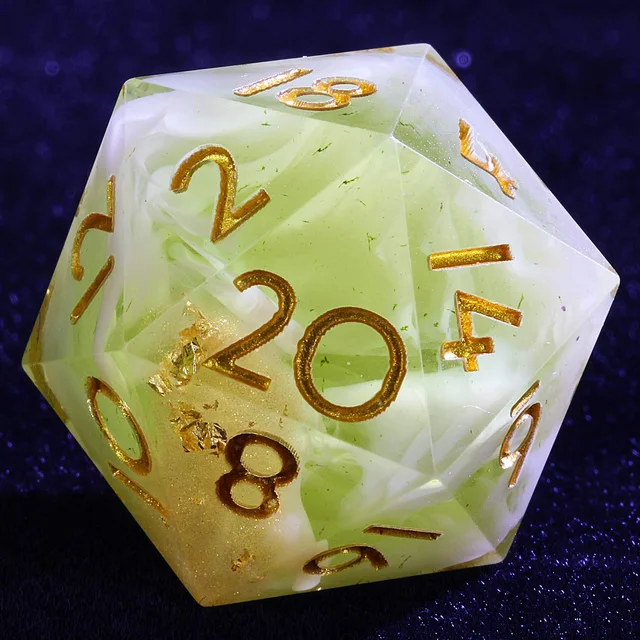 Close-up of a pale yellow-green D20 with white swirls, gold flecks and gold numbers.