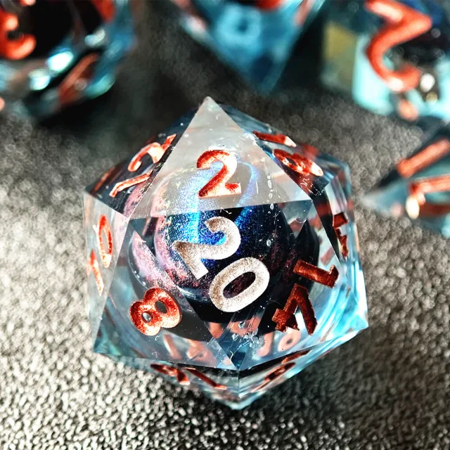 Close-up of a blue eye-core D20 showing a white 20.