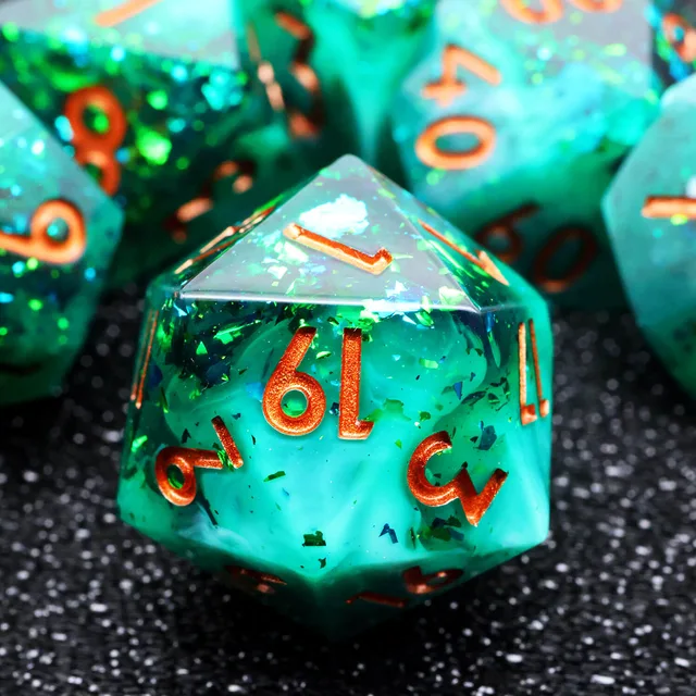 Close-up of a turquoise and green D20 with copper-orange numbers and reflective flecks.