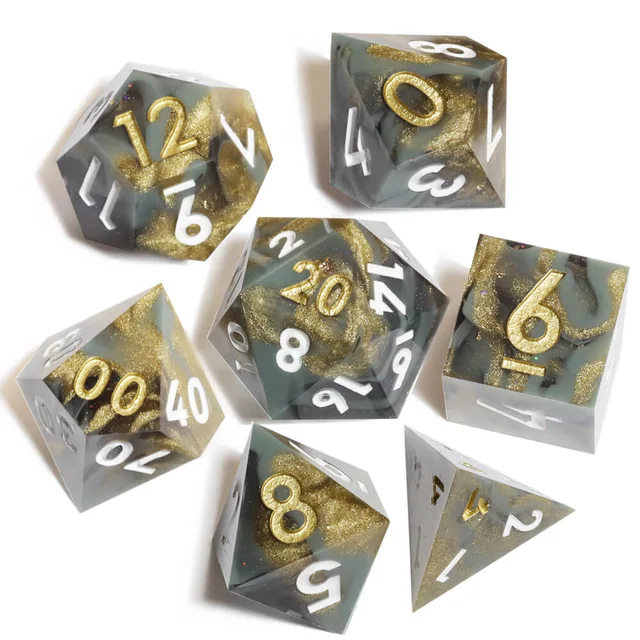 Seven smoky grey and gold-shimmer polyhedral dice on white