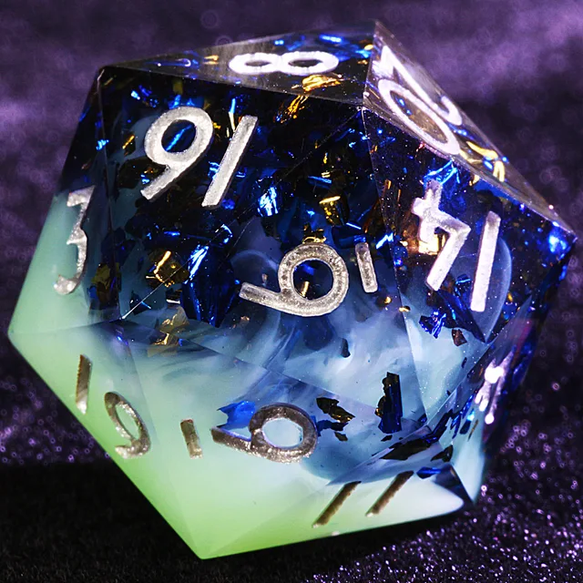 Close-up of a blue and mint-green D20 with reflective flecks and pale numerals.