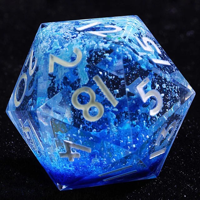 Close-up of a transparent blue D20 with pale numerals and icy blue inclusions.