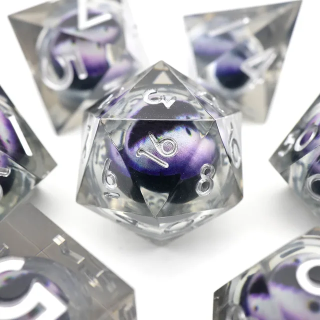 Close-up of a clear D20 with a purple-grey eye-like core and silver numbers.