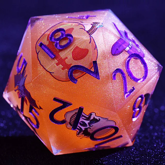 Close-up of a glittery orange D20 with purple numbers, a jack-o'-lantern, bats and a grinning skull.