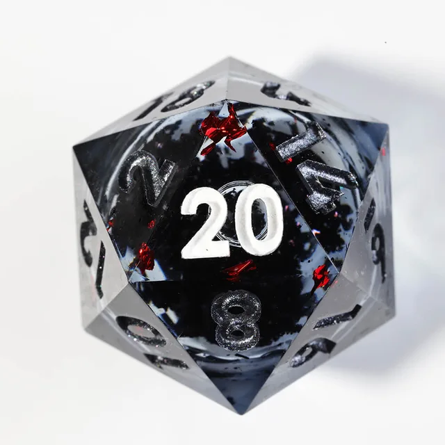 Close-up of a smoky black D20 with red flecks and white 20.