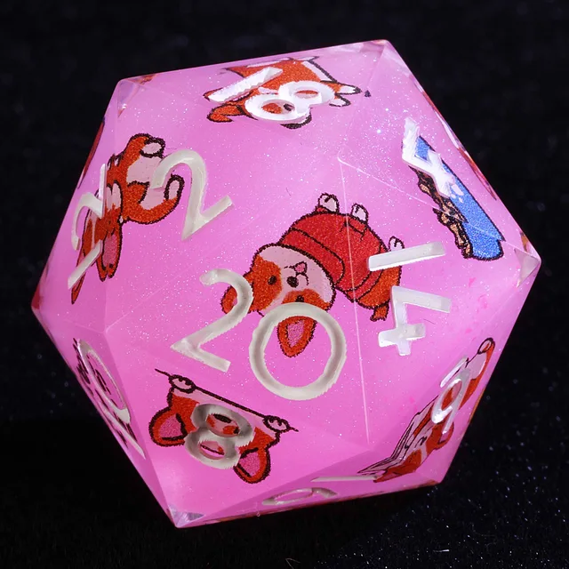 Close-up of a pink sparkling D20 with white numerals and orange-and-white corgi illustrations.