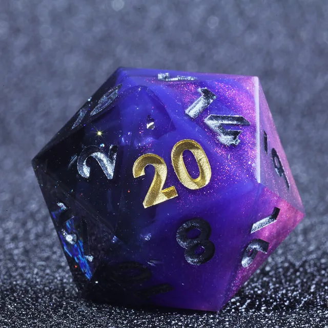 Close-up of a purple glitter D20 with gold and silver numerals