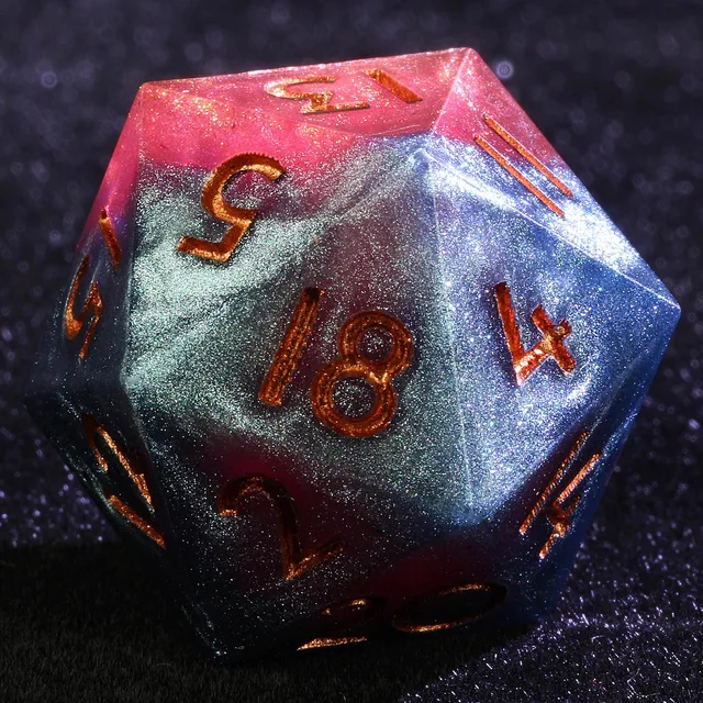 Close-up of a glittering blue and crimson-pink D20 with copper-gold numbers.