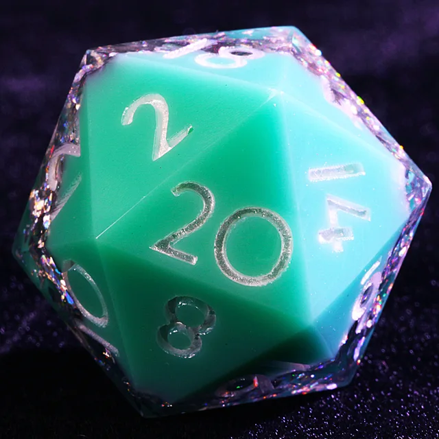 Close-up of a turquoise and green D20 with silvery numbers and reflective flakes.