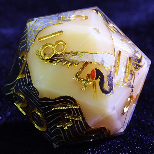 Close-up of the blue and cream-white D20 with gold numbers and fine wave patterns.