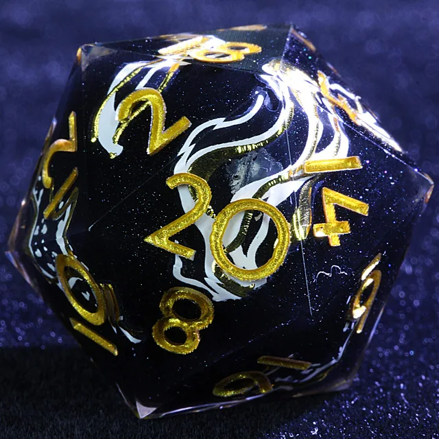 Close-up of a dark glitter-speckled D20 with white and gold ribbons and gold numbers.